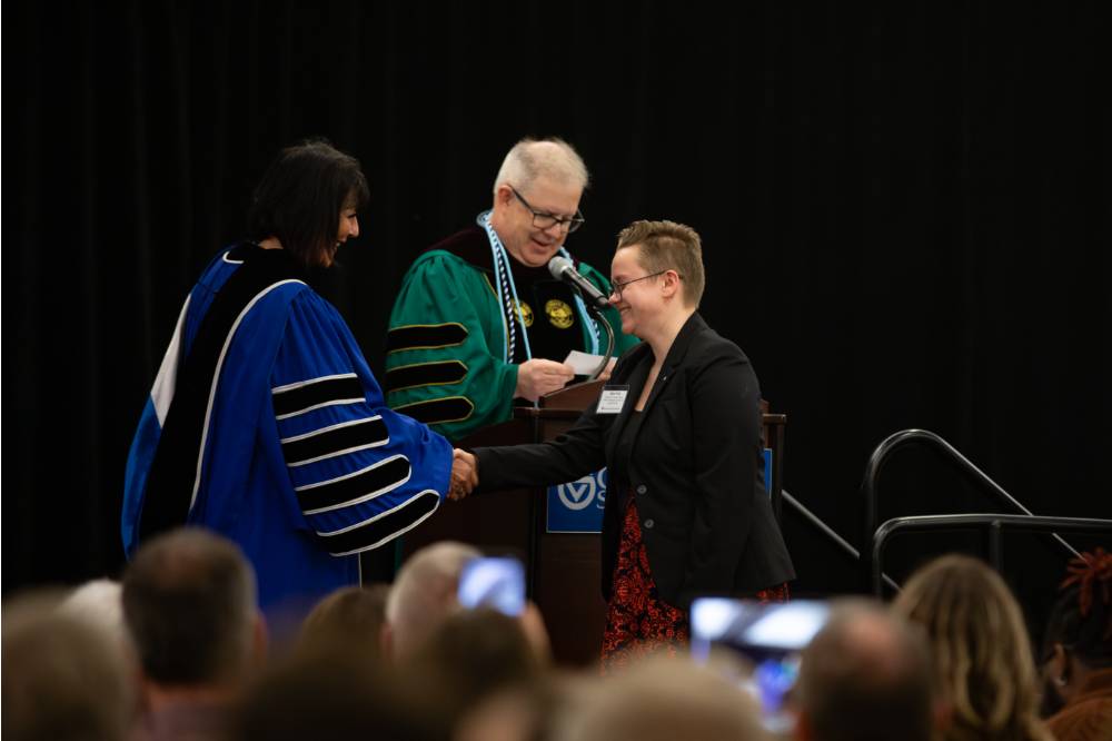 Student shaking hands with President